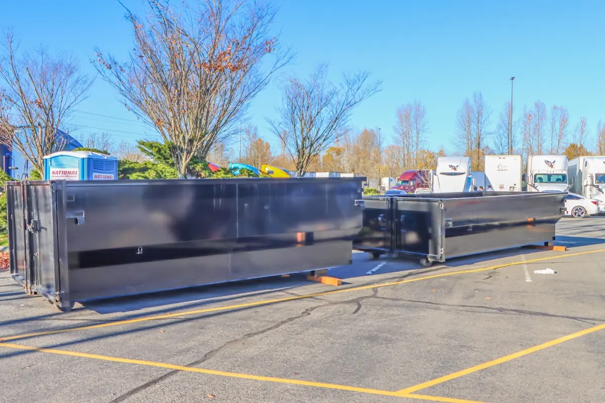 Professional dumpster rental service with roll-off container on residential driveway in Hamlin